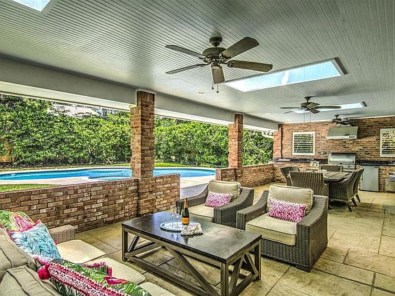 Before we step the inside, just had to share this 600 square foot covered patio with a mosquito misting system and fully equipped outdoor kitchen! What an entertainer's dream.