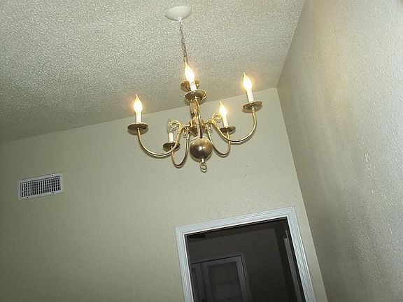 Vaulted ceiling and chandelier in living room.