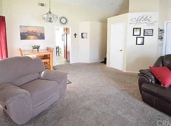 Living room facing the dining area and entrance to the kitchen.