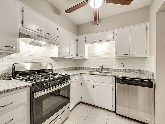 Updated SS gas range, dishwasher, vent hood, granite countertops and subway tile backsplash