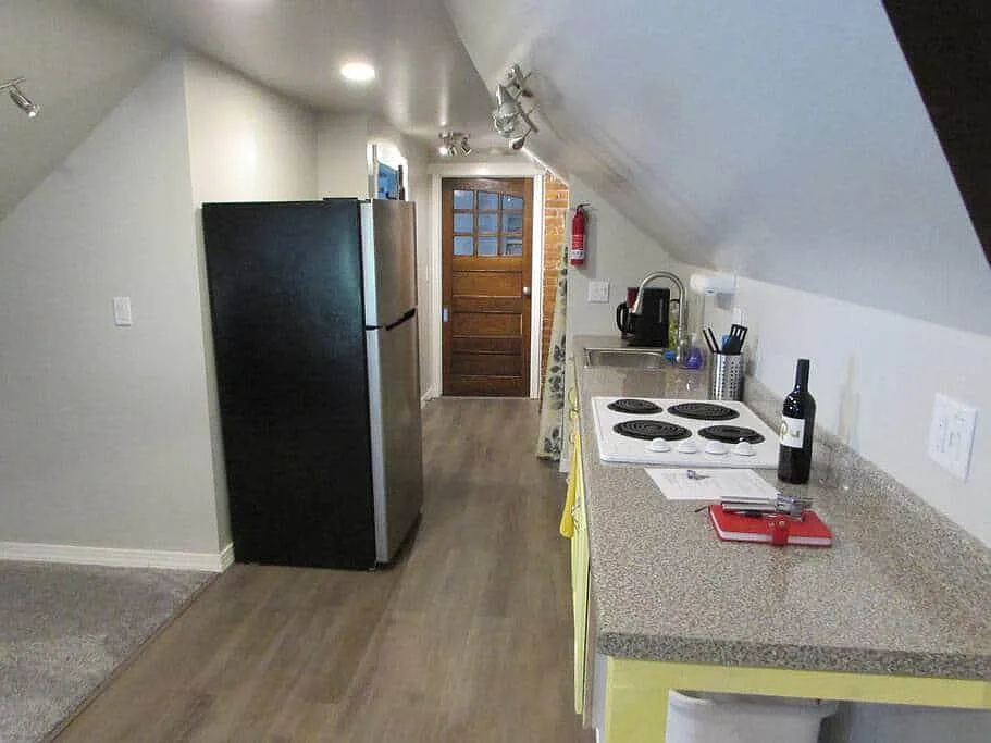 Stocked Kitchenette with plates, pots, pans and cooking utensils