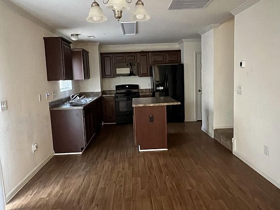 Dining area & Kitchen from great room; stairs on right, sliding glass door on left