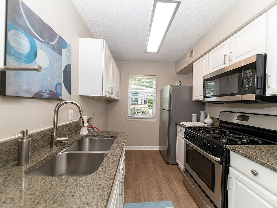 Kitchen with granite counters, modern cabinetry, and stainless appliances