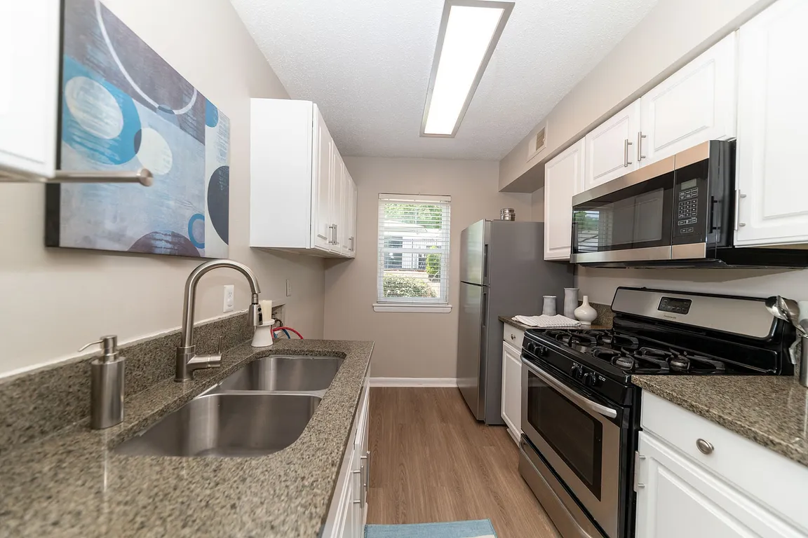 Kitchen with granite counters, modern cabinetry, and stainless appliances