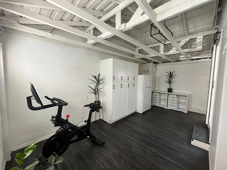 Bonus room view from driveway door... Cupboards and new fridge included. Peloton not included