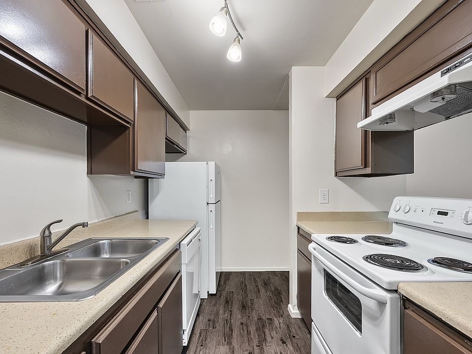 Apartment kitchen featuring generous cabinet storage, breakfast bar, and full-size appliances with a functional layout.