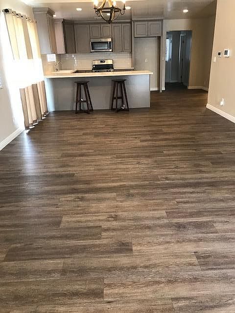 New wood look LVP flooring and carpet in bedrooms, new stain