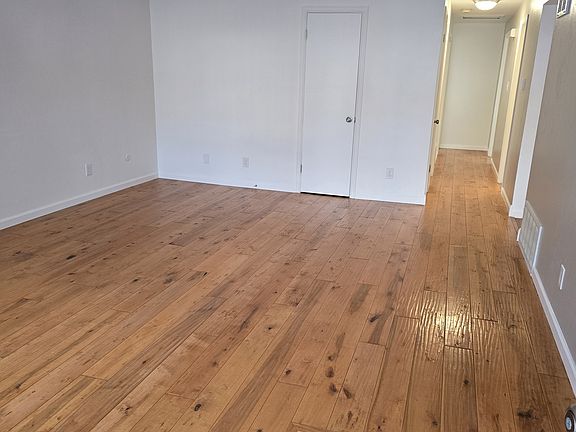 Carpeted bedrooms with hardwood, vinyl plank and tile floors in other areas
