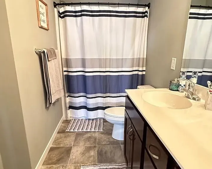 Elevate your living experience at LS Capital Group with this stylish bathroom featuring modern fixtures, ample storage, and a soothing color palette. Ideal for relaxation and everyday routines. Schedule your tour today to see it all!