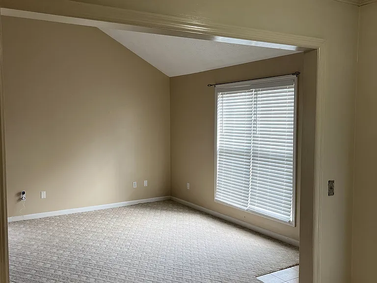 Looking from Kitchen into front of home, tile entranceway on right.