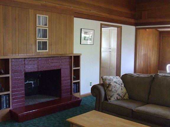 Living room with vaulted ceilings and fireplace