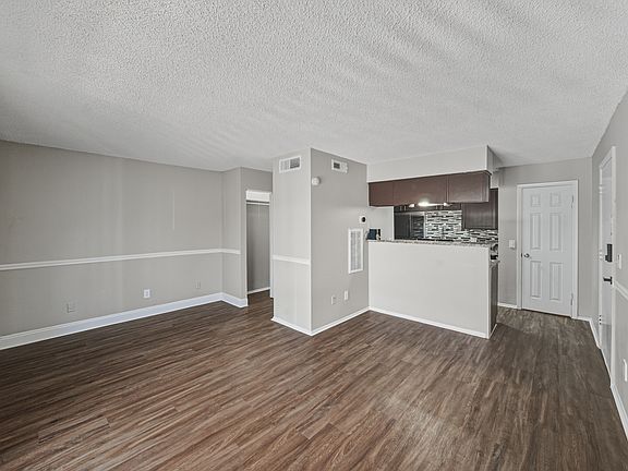 Spacious open-concept living area with modern flooring