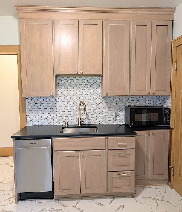 [LOWER UNIT]: Newly remodeled kitchen with stainless steel appliances, leathered granite countertops, solid wood cabinets, luxury vinyl tile flooring with Carrara Marble aesthetic, champagne gold fixtures