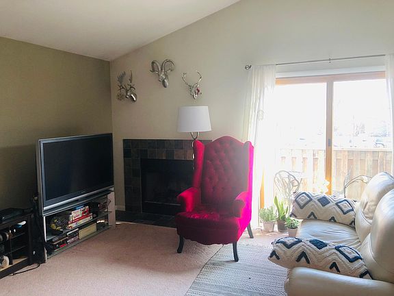 Living area, functional fireplace, better view of deck