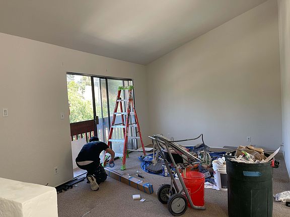 Living room facing sliding door & wall