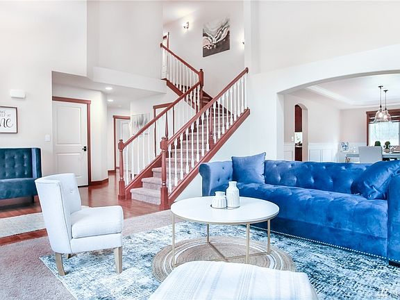 Living Room Flows Into Formal Dining - Also a Grand Staircase Leads to the Upper Rooms...