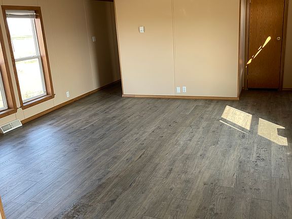 Living room view from dining area. new paint ,windows &LVT. Has a coat closet by front door. Large deck off front nice for relaxing and BBQ