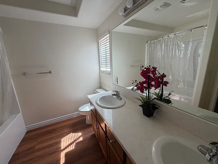 Recently renovated shared bathroom with double sinks