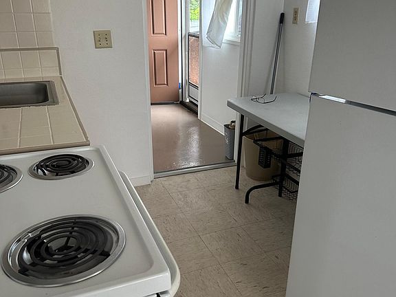 Kitchen leading to enclosed carport. No disposal unit under sink