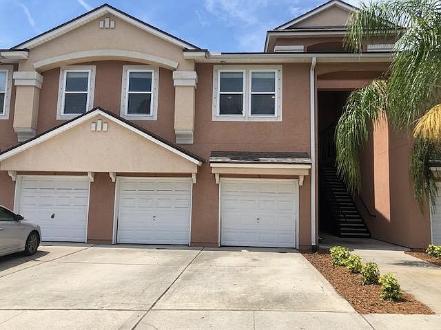 Front of the condo and the 4 windows on the 2nd floor level are to the living room and master bedroom. Front door is in the covered breezeway on the right.