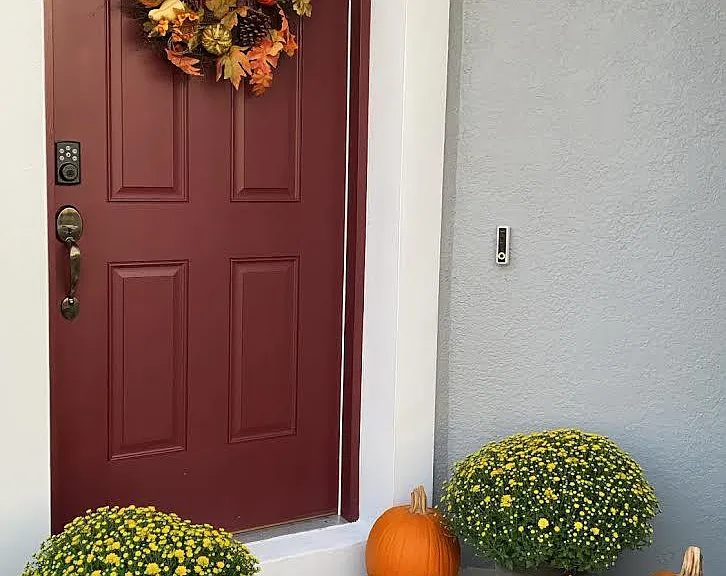 Front door with ring camera, smart lock, and brick walkway