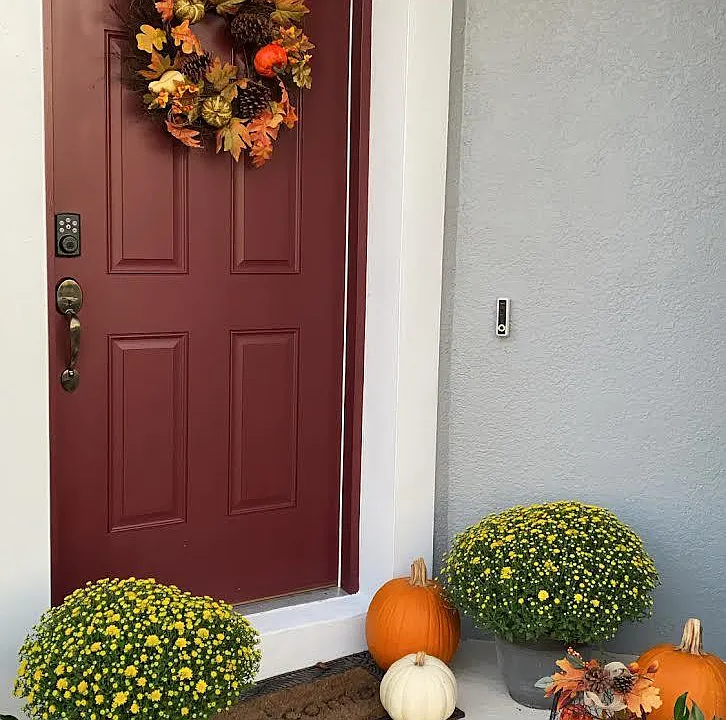 Front door with ring camera, smart lock, and brick walkway