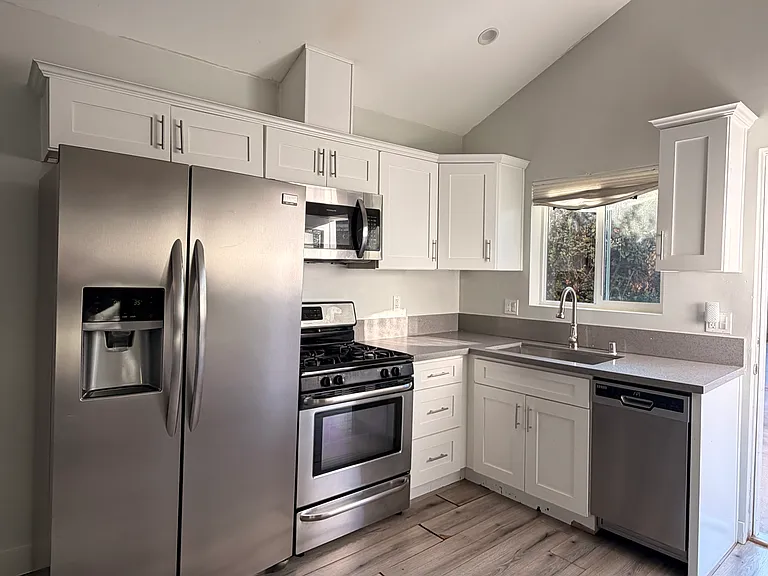 Kitchen with refrigerator, dishwasher, microwave, and stove