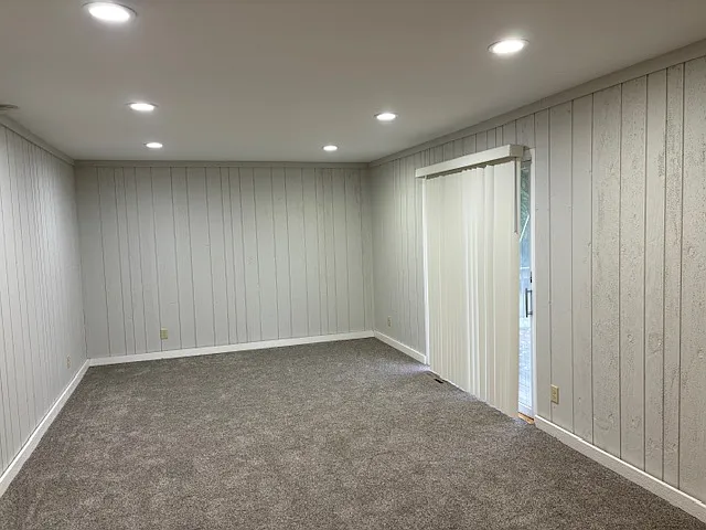 Bright south facing family room, new carpeting and patio door treatment