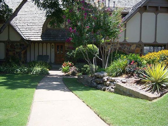 Charming entrance on lushly landscaped corner lot. Pretty in every season! 