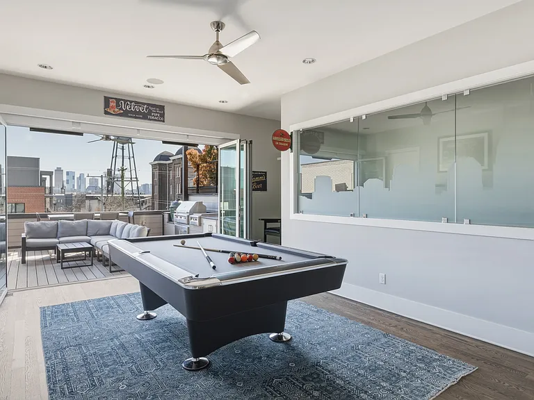 Upstairs game room connected to the rooftop patio and mini bar_an ideal hangout space for friendly competition and evening cocktails.