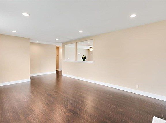 Living room view of entry & peek-thru to Family/Dining area.