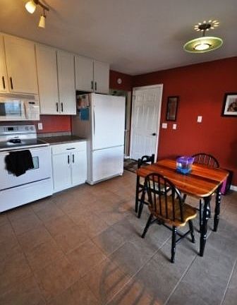 Eat-In Kitchen - Sliding glass door walks out onto screened porch/deck.
