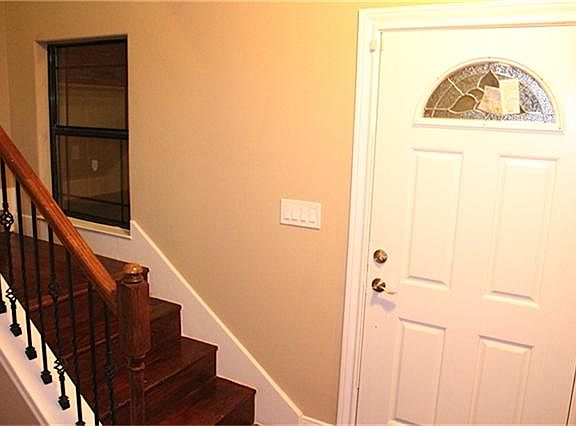 Detailed entrance with cast iron stair rails captures the eyes and keeps the space open