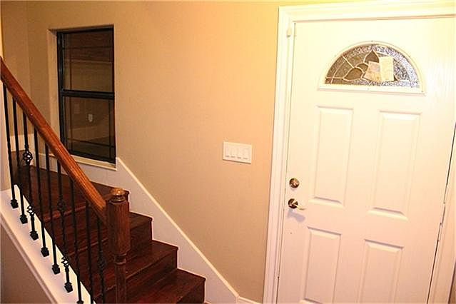 Detailed entrance with cast iron stair rails captures the eyes and keeps the space open