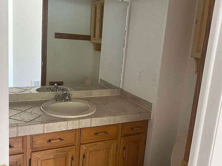 2nd bathroom has single sink and tub with shower