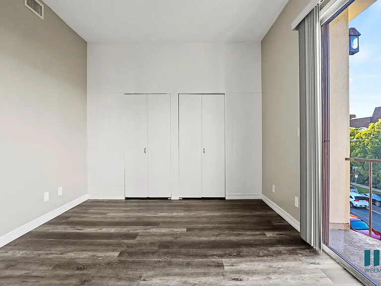 Bedroom with Double-Closets, Vinyl Flooring, and Balcony