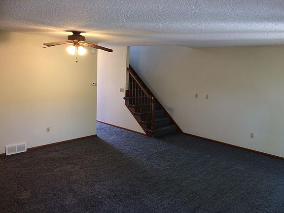 View from the living room towards the main stairwell and the entrance hall (with large, walk-in closed and half-bath)