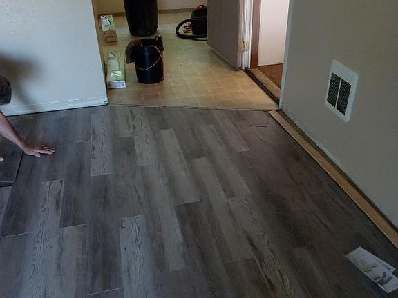 New living room flooring and entry to the dinette and kitchen area.
