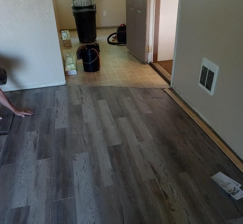 New living room flooring and entry to the dinette and kitchen area.
