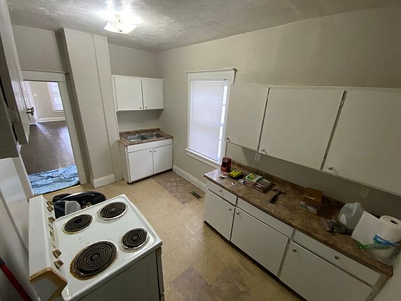 Large kitchen with brand new refrigerator.