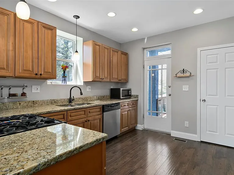 Huge Kitchen with SS appliances, Granite Countertops, 42" cabinets with soft close, Engineered Floor, and walk-in pantry!