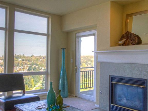 Wonderful views and light through oversize windows with top-down, bottom-up shades. Alcove over the fireplace can accommodate a TV or art.