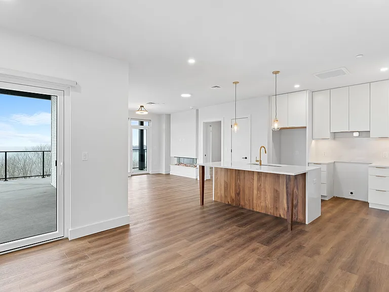 Unit 510 Kitchen & Dining Space with Balcony to the left overlook Lake Champlain