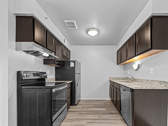 Upgraded Kitchen with stainless steel appliances and granite countertops at Westwood Village Apartments in Westland, MI