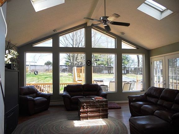Livingroom with a breathtaking wall of windows overlooking the fenced yard