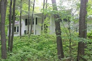 LARKIN TOWNSHIP FOUR BEDROOM HOME NESTLED ON TWO ACRES!! Two car attached garage with new door and two sheds. Front covered porch. Five minutes to Midland Mall. Two full bathrooms. Brick fireplace in the living room. Lots of living space and storage. New windows 2006. Large three season porch spans across the back. Private setting. Midland Schools