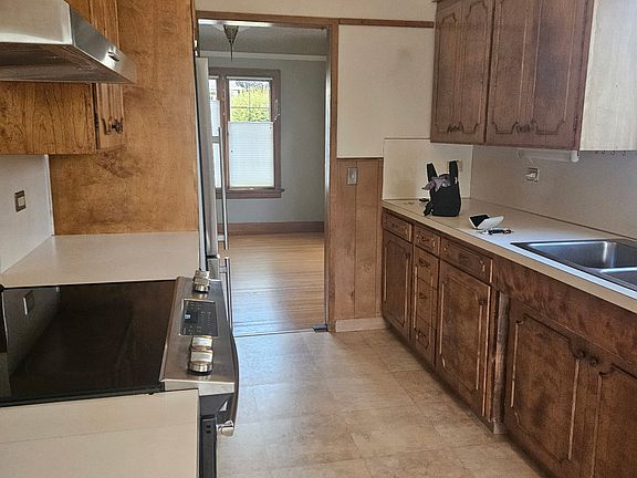 Kitchen with SS appliances and double sink.