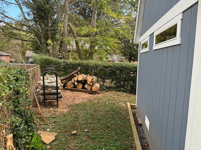 AREA BEHIND STORAGE SHED (WOOD AND RACKS NOT STAYING WITH HOME)