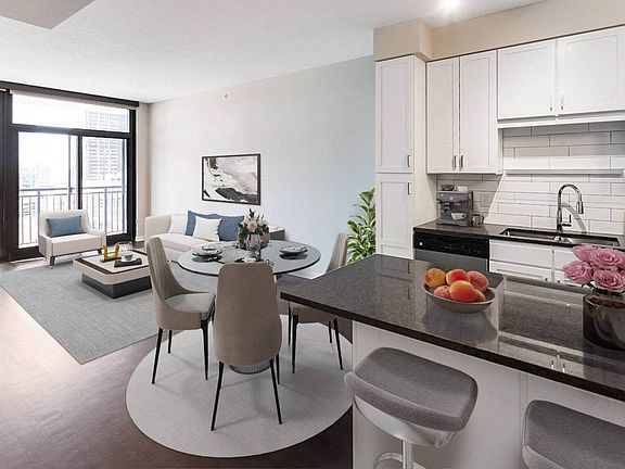 Nic on 5th Apartments in Minneapolis, Minnesota- Large furnished kitchen and living room with wooden floors and tall windows