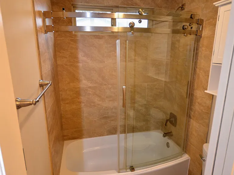 Main bathroom shower separated by pocket door
